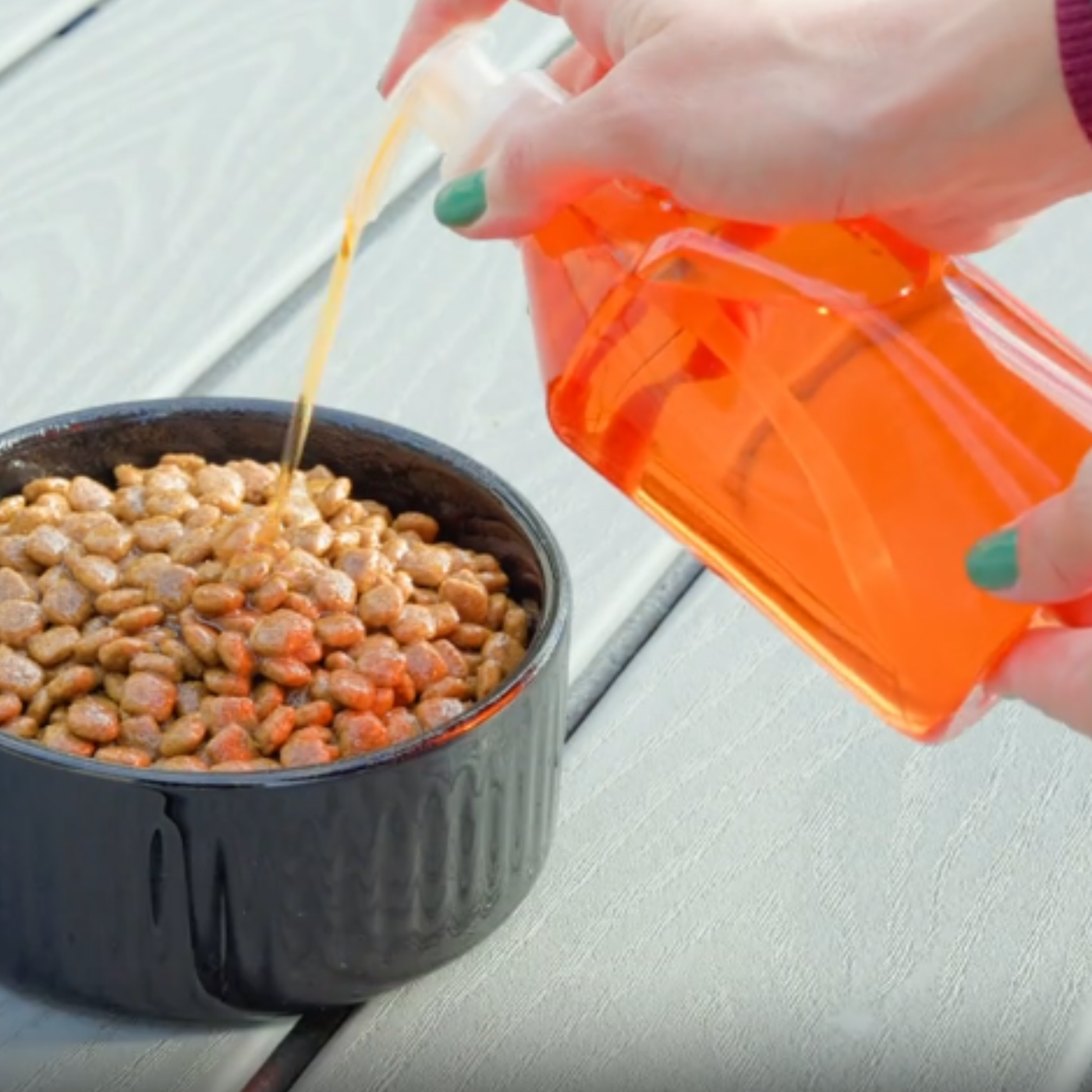 Messy fish oil pump bottle dripping on a kitchen counter