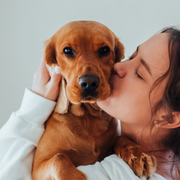 A pet parent with their dog, representing the FAM Pets brand