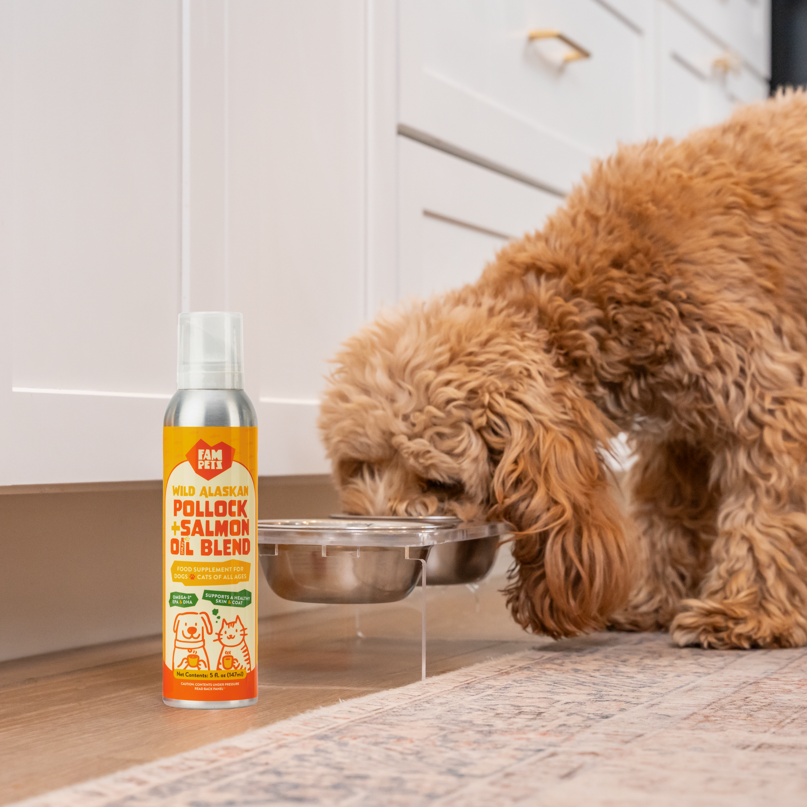 Dog eating from a bowl beside a bottle of FAM Pets Omega-3 Fish Oil Spray