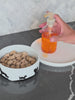 A traditional fish oil pump bottle showing a messy, air-exposed pour
